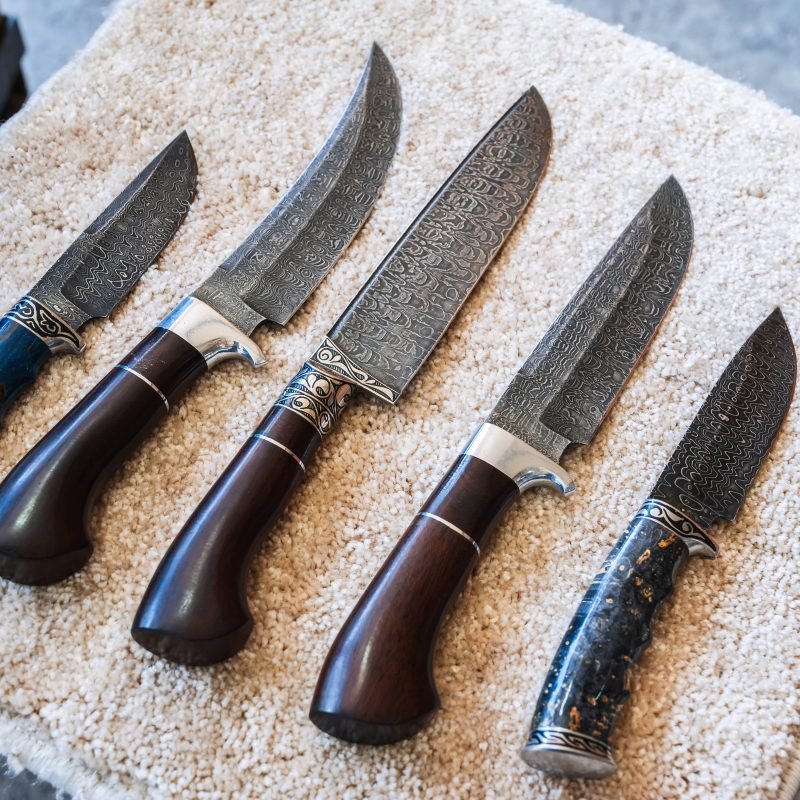 traditional oriental Uzbek chust knives made of Damascus steel with wooden handles in bazaar in Uzbekistan